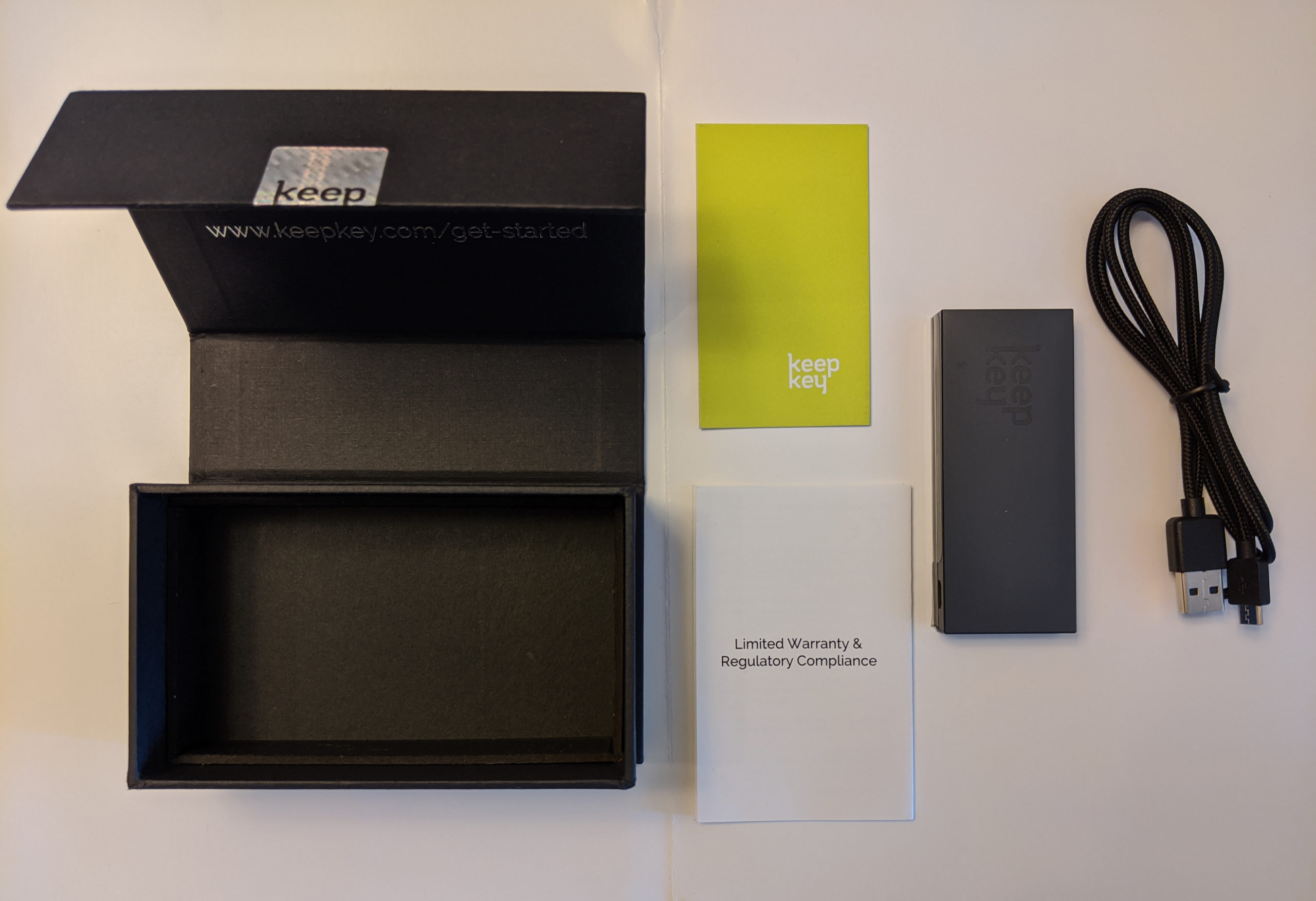 An image of all of the accessories came with the KeepKey hardware wallet and the case that holds them. 